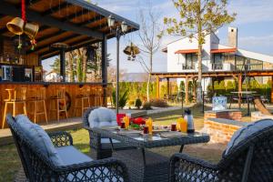 a patio with a table and chairs and a bar at Monk By The Lake Sapanca in Sapanca