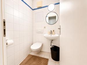 a bathroom with a toilet and a sink at City Lodge Leipzig in Leipzig