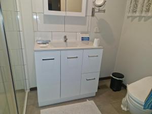 a bathroom with a white sink and a toilet at Private Studio Ensuite & Kitchenette in Glen Waverley