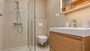 a bathroom with a shower and a toilet and a sink at Villa Aquiterra Bobovisca in Bobovišća +12 photos