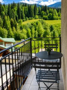 a table and chairs on a balcony with a view at Mansarda Ossana in Fucine