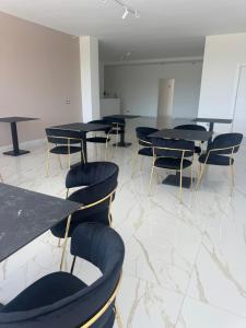 a conference room with black tables and chairs at Hotel Doc in Vairano Scalo