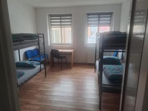 a room with bunk beds and a table and chairs at Pokoje gościnne in Lubniewice