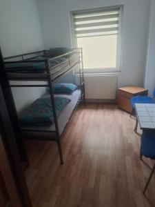 a room with two bunk beds and a table at Pokoje gościnne in Lubniewice +11 photos