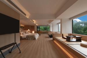 a hotel room with a bed and a flat screen tv at L'Eau Vive de Qixi Meidi - Riverfront Infinity Pool & Log Cabin Cafe - Outdoor Cooking Class - Complimentary Shuttle within 8 Kilometers in Yangshuo