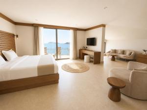a bedroom with a bed and a living room at Villa Hotel Tamara in Kaş