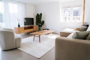 a living room with two couches and a coffee table at Oase in Bergen