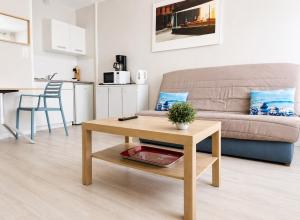a living room with a couch and a coffee table at Studio - Pleine Mer - 1 avenue des Pays de Monts - 1-1 in Saint-Jean-de-Monts
