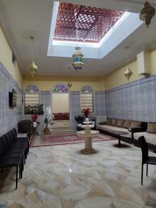 a lobby with couches and a fountain in a building at Chambre d'hôte in Midelt