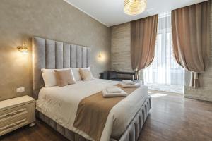 a bedroom with a large bed with a large window at Trieste Centro Rooms-camere eleganti in pieno centro in Trieste