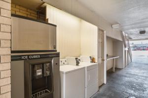 a kitchen with a stove top oven next to a wall at Motel 6-San Antonio, TX - Fiesta Trails in San Antonio