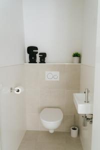 a bathroom with a toilet and a sink at Oase in Bergen +28 photos
