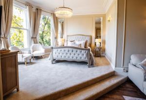 a bedroom with a bed and a large window at Woodland Manor Hotel in Bedford +115 photos