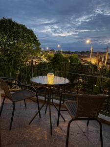 a table and chairs on a patio with a view at Casa Cristian Techirghiol in Techirghiol