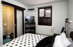 a bedroom with a bed with black and white stars on it at Apartment Casa Sarajevo in Sarajevo +33 photos