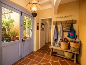 a hallway with a door and a entry way at 'Cardamom House', Enchanting Vacation Home 2 min from the Beach, Sleeps 5 in Gordonʼs Bay +24 photos