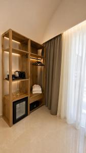 a room with a book shelf and a window at The Wine Suites in Rhodes Town +23 photos