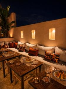 a living room with a couch and tables and lights at Riad Timoun in Agadir