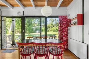 a dining room with a table and red chairs at 1007-N-Hundested-Humlehaven-5 in Hundested