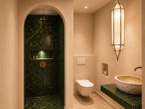a bathroom with a shower and a sink and a toilet at Riad Timoun in Agadir +20 photos