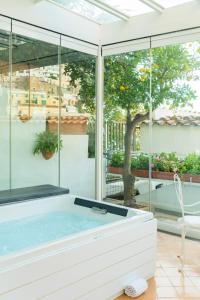 a jacuzzi tub in a room with a window at Hotel L'Ancora in Positano
