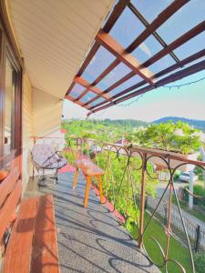 a balcony with a table and a bench and a view at U Nazara in Slavske