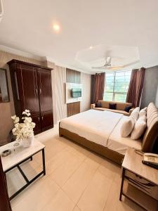 a large bedroom with a bed and a couch at Hotel Islamabad Premiere Inn in Islamabad