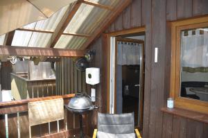 a room with a table and a lamp and a window at Ferienwohnung Wildgatter in Grafenwiesen