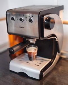 a espresso machine sitting on a counter with a cup at Casa Mediterrània in Xeraco