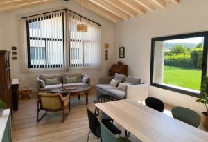 a living room with a couch and a table at La Llarena in La Isla +15 photos