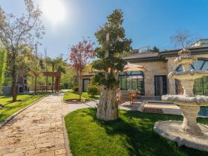 a courtyard with a fountain in front of a house at Arborea Hotel in Trabzon