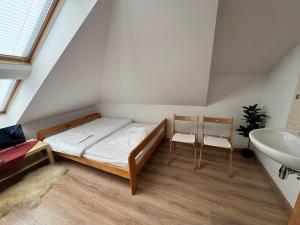 a small room with a bed and a sink at Motel S7 in Goszczyn