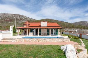 a house with a swimming pool in a yard at Villa Dea in Vučevica