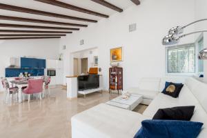 a living room with a white couch and a table at Villa Dea in Vučevica