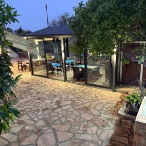 a patio with a pavilion with a table and chairs at La Maroja View Hotel in Dhërmi