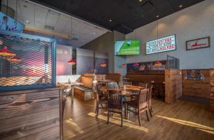 a dining room with tables and chairs in a restaurant at Coast Chilliwack Hotel by APA in Chilliwack
