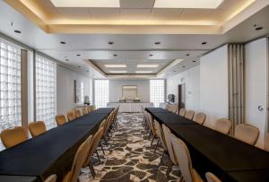 a conference room with a long table and chairs at Coast Chilliwack Hotel by APA in Chilliwack +44 photos