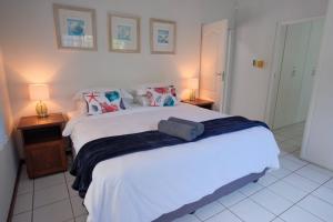 a bedroom with a large white bed and two lamps at Kuda Breeze in St Lucia +50 photos