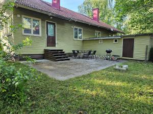 a house with a patio with chairs and a grill at House for 4 person near Meyer Turku in Turku