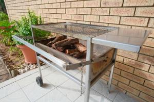 a barbecue cart sitting next to a brick wall at Kuda Breeze in St Lucia