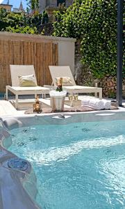 a swimming pool with a table and chairs next to at Hotel Sant'Andrea in Santa Margherita Ligure
