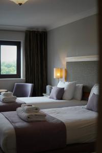 a hotel room with two beds and a window at Wolfscastle Country Hotel in Haverfordwest +85 photos