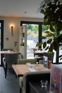 a restaurant with tables and chairs and a large window at Wolfscastle Country Hotel in Haverfordwest