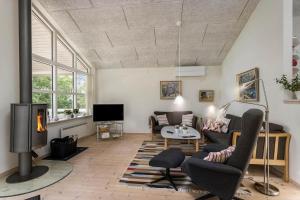 a living room with a couch and a fireplace at FY166-Middelfart-Skrillinge-Strand-100 in Middelfart