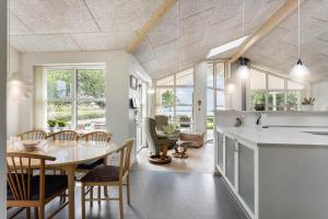 a kitchen and dining room with a table and chairs at FY166-Middelfart-Skrillinge-Strand-100 in Middelfart