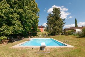 a swimming pool in the yard of a house at Villa Il Rossignolo con Piscina in Grassina