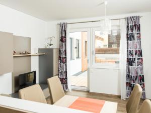 a dining room with a table and chairs and a window at Apart Peter in Seefeld in Tirol