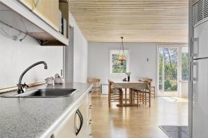 a kitchen with a sink and a dining room at C11306-Tarm-Hjortevej-10 in Tarm