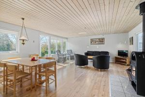a living room with a table and chairs and a couch at C11306-Tarm-Hjortevej-10 in Tarm