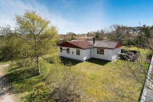 a white house with a red roof on a yard at C11306-Tarm-Hjortevej-10 in Tarm